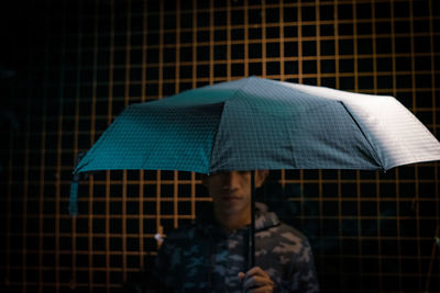 Close-up of a man with umbrella