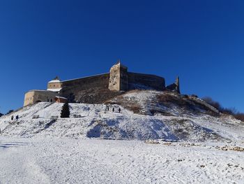 Low angle view of castle against clear blue sky