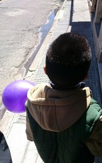 Rear view of two boys on road