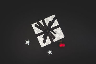 Close-up of christmas decorations over black background