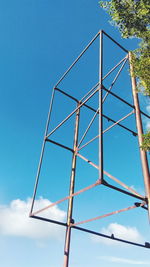 Low angle view of trees against blue sky