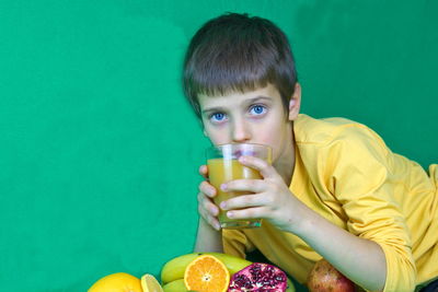 Portrait of boy drinking water from glass