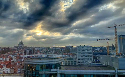 High angle view of buildings against cloudy sky