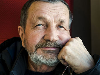 Close-up portrait of senior man in train