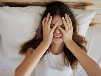 Portrait of woman lying on bed