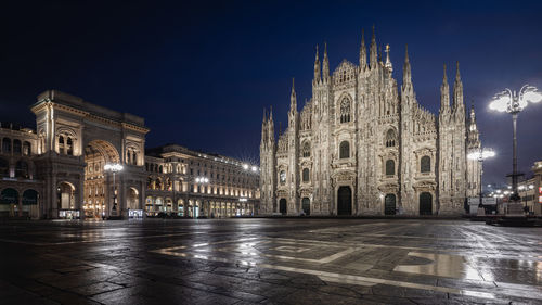 Illuminated building against sky at night