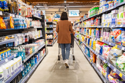 Rear view of woman walking in supermarket