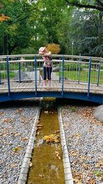 Woman standing on footbridge