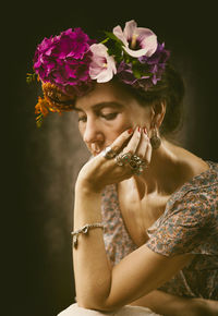 Woman with flowers on her head recalling the style of frida vi