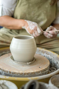 Woman making pottery on the wheel