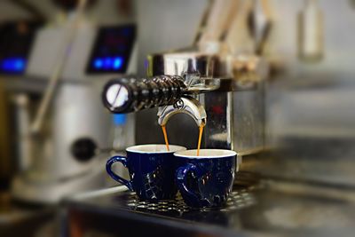 Close-up of coffee pouring in glass