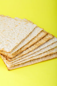 High angle view of bread on plate against yellow background