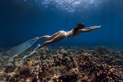 Low section of woman swimming in sea