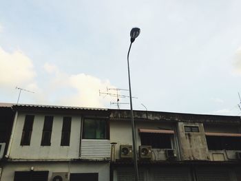 Low angle view of building against cloudy sky