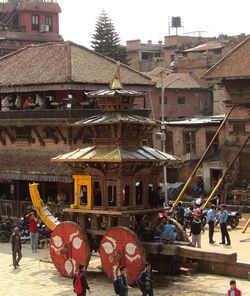 People in front of buildings in city