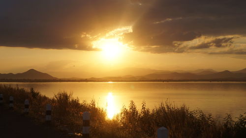 Scenic view of lake against sky during sunset