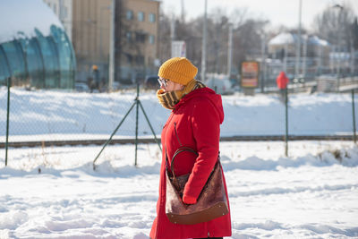 Side view of person standing on snow covered land