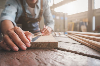Midsection of woman working on table