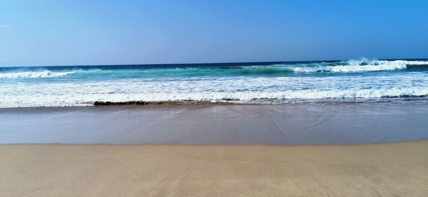 Scenic view of beach against clear sky