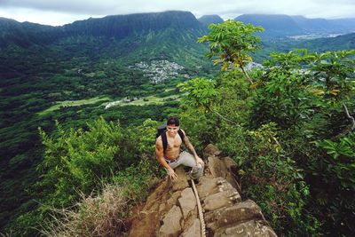 High angle view of shirtless man climbing mountain