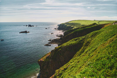 Scenic view of sea against sky at lizard point in cornwall, england