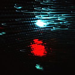 Close-up of illuminated reflection in water