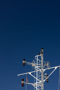 Low angle view of ship against clear blue sky