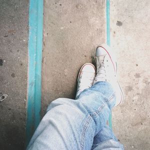 Low section of man wearing shoes while standing on steps