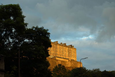 Low angle view of historical building against cloudy sky