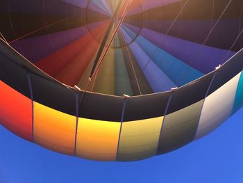 Low angle view of hot air balloon against blue sky