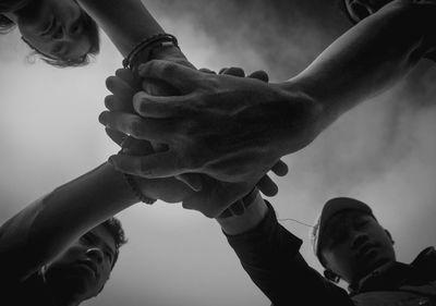 Low angle view of people at hands