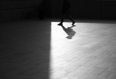 Low section of man walking on floor