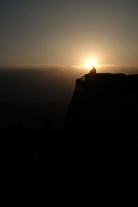 Scenic view of silhouette mountain against clear sky during sunset