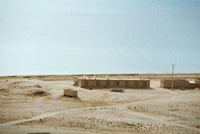 Built structure on desert against clear sky