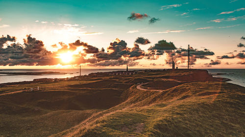 Scenic view of beach against sky during sunset