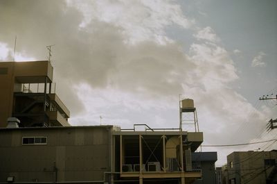 Low angle view of building against cloudy sky