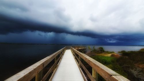 Pier over sea against sky