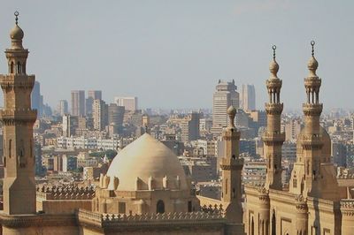 Buildings in city against clear sky