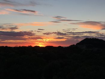 Scenic view of silhouette mountains against sky during sunset