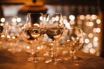 Close-up of wine glasses on table
