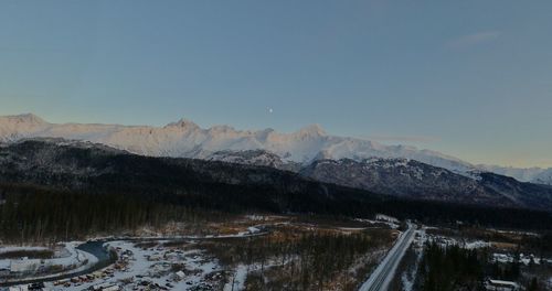 Scenic view of snowcapped mountains against clear sky