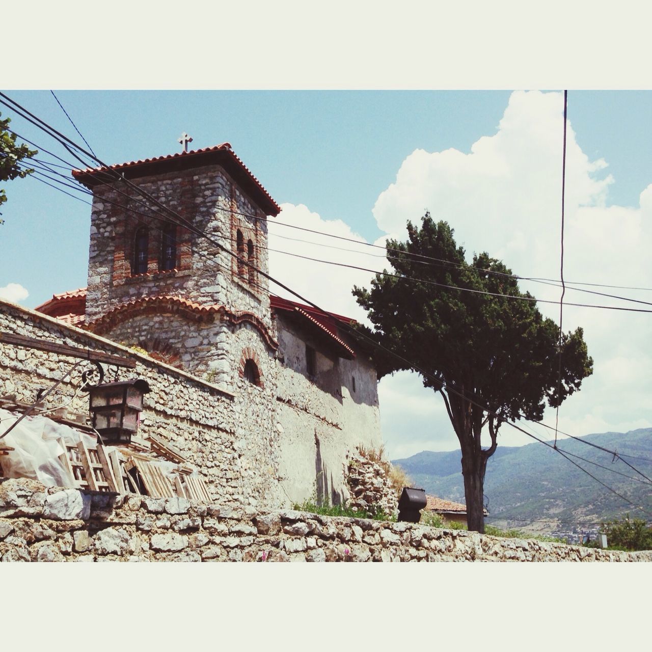 architecture, built structure, building exterior, sky, transfer print, low angle view, tree, auto post production filter, history, old, church, tower, religion, place of worship, cloud - sky, day, outdoors, no people