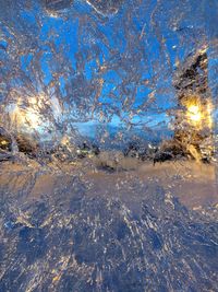 Snow covered land against blue sky