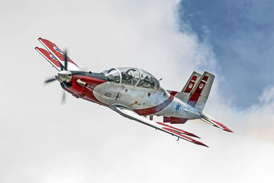 Low angle view of airplane flying against sky