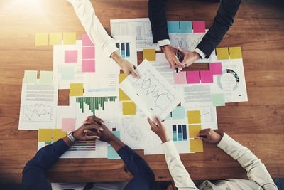 Midsection of business colleagues working on table