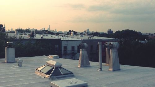 Sculpture in city against sky