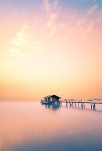 Scenic view of sea against romantic sky at sunrise