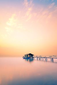 Scenic view of sea against romantic sky at sunrise