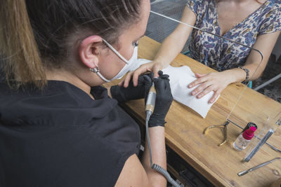 High angle view of woman sitting on table