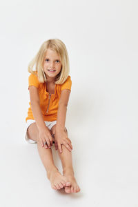 Portrait of smiling young woman against white background